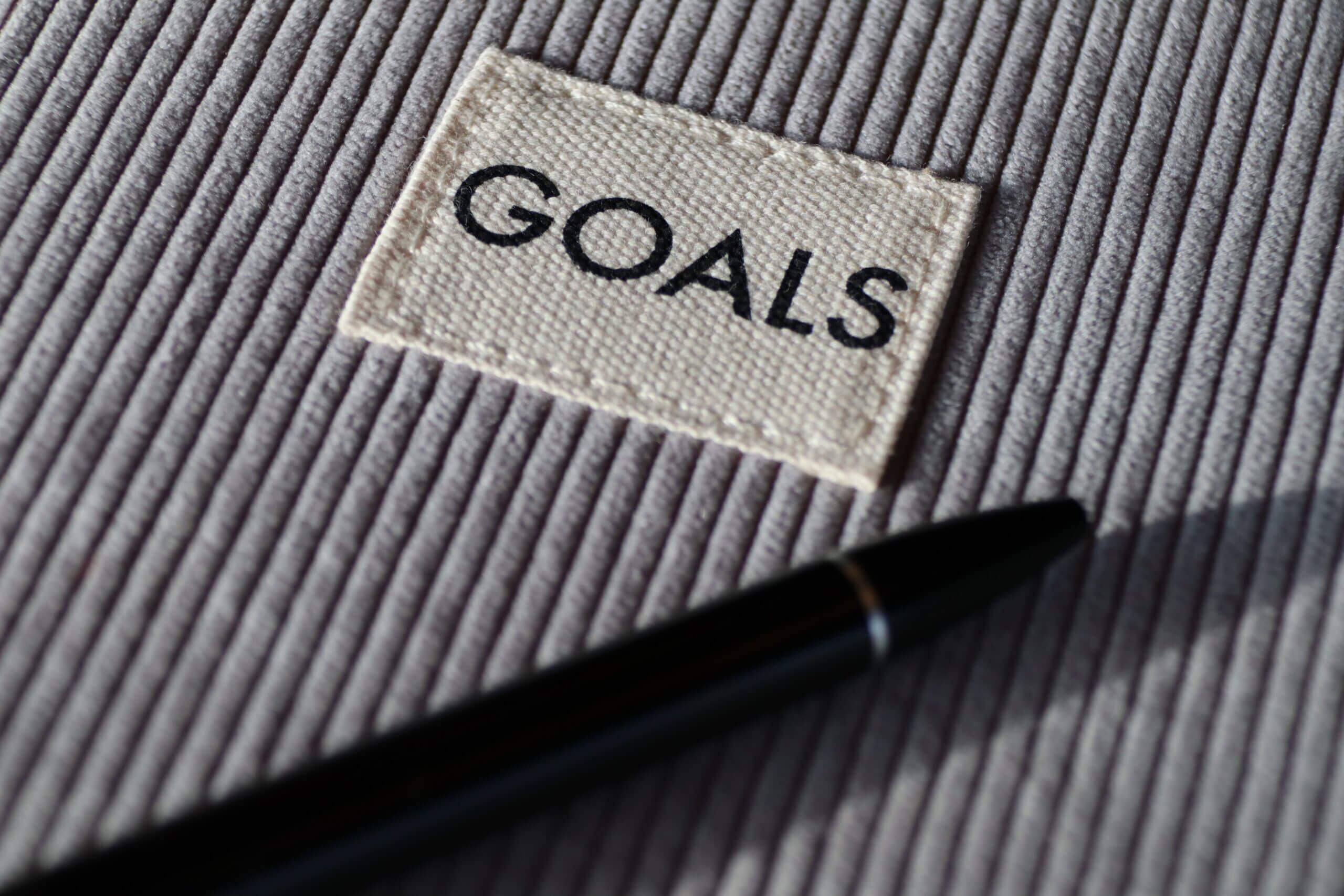 A label of goals with a pen in front